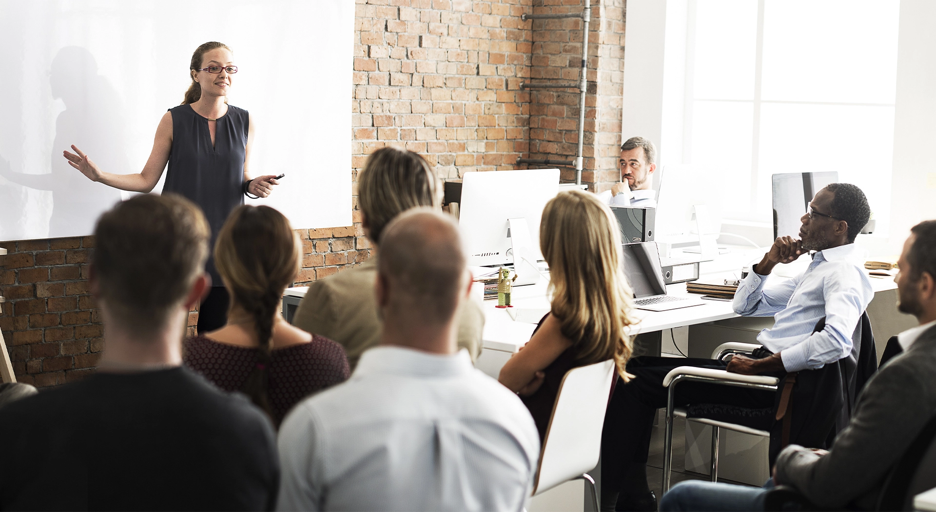 lady delivering crisis communications training to a room of people