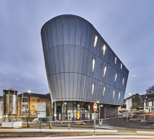 Image of a laptop screen showing some PR coverage Fabrick's construction PR team achieved for Jenner Group on the F51 skatepark project and a photo of the exterior of F51 in Folkestone, Kent