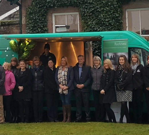 Members of the A.Proctor Group team gather outside their UK tour van