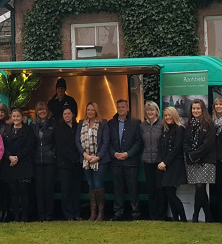 Members of the A.Proctor Group team gather outside their UK tour van